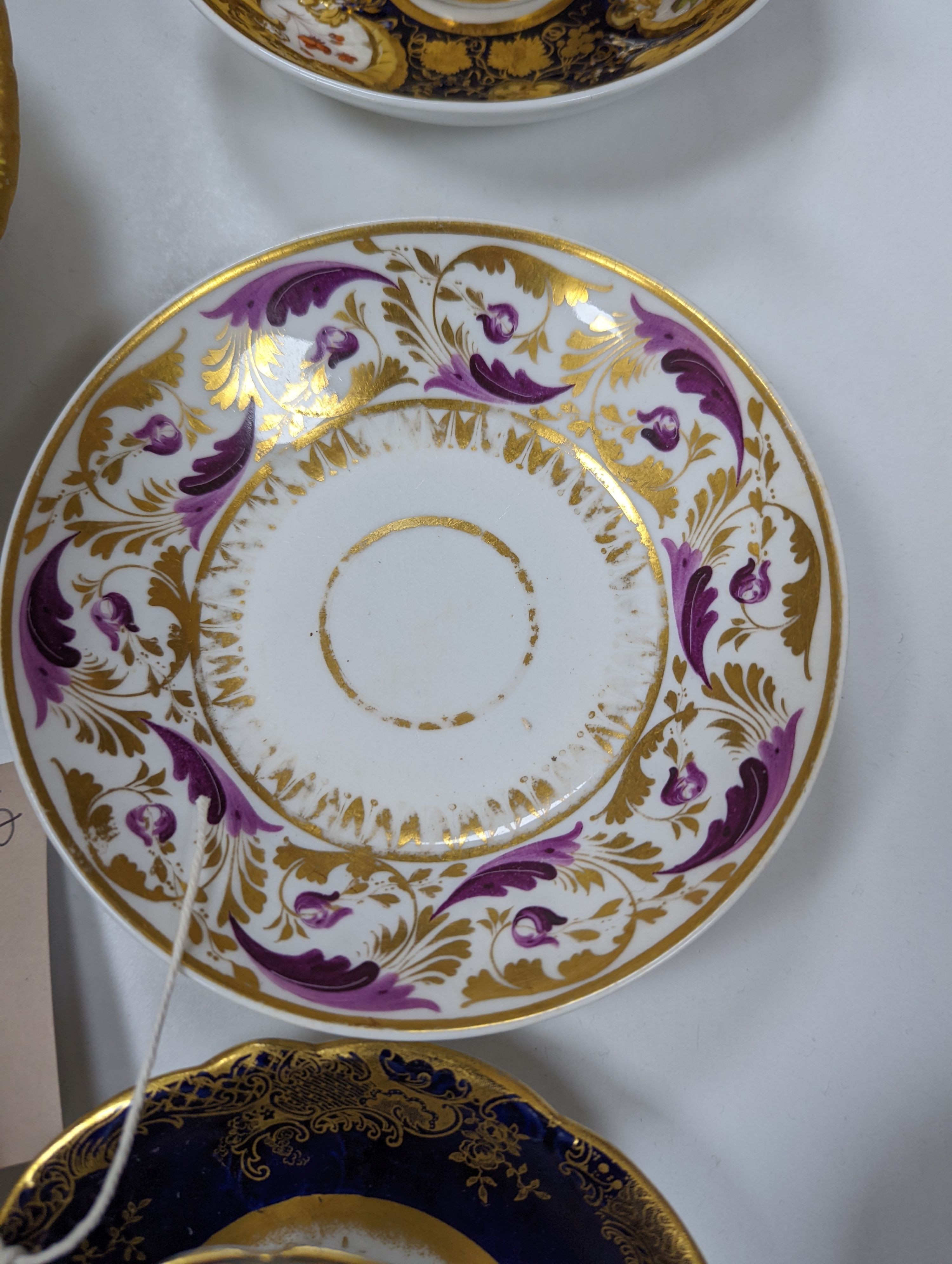 A small collection of Victorian porcelain tea cups and saucers and sundry dessert plates